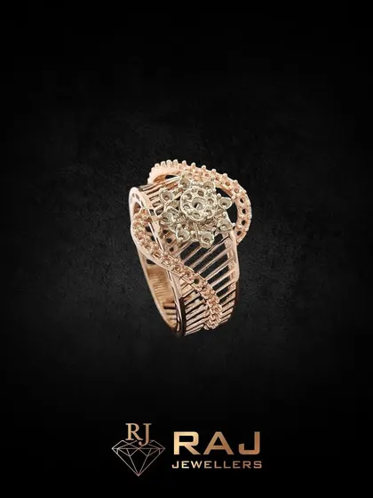 This intricately designed cocktail ring features a floral centerpiece with a detailed, openwork band. Crafted in rose gold and CZ, it is a beautiful piece of wearable art.