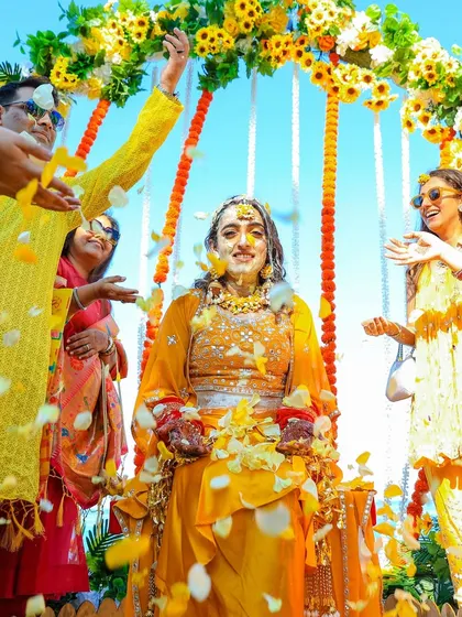 A classic Phoolon ki Holi moment, with the bride being showered in flower petals by her family and friends.