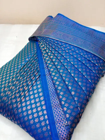 A beautiful blue saree with copper-toned butis. The pleats are set to create a stunning drape, making it easy for you to look your best.