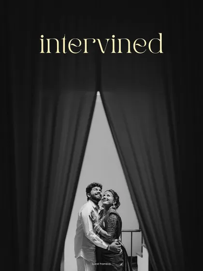 "Intertwined." A dramatic black and white portrait of a couple framed by curtains, creating a theatrical and cinematic feel.
