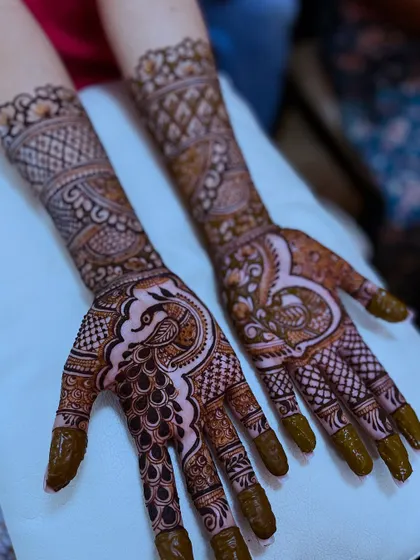 Another angle of the peacock henna design, showing the intricate details and the beautiful flow of the pattern.