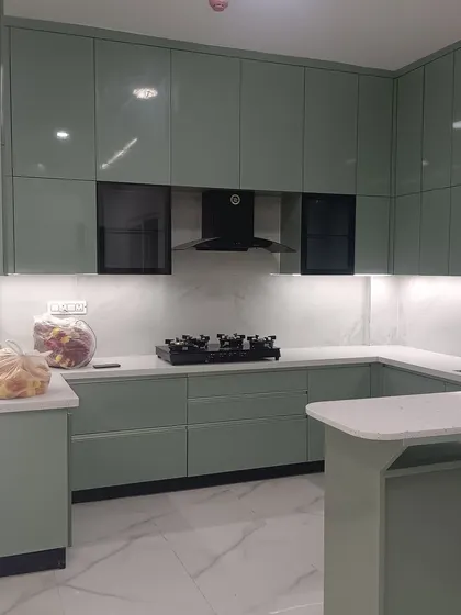 This shot captures the full scope of the U-shaped kitchen with its breakfast bar. The design demonstrates our ability to create highly functional work triangles while maintaining a beautiful, cohesive look.