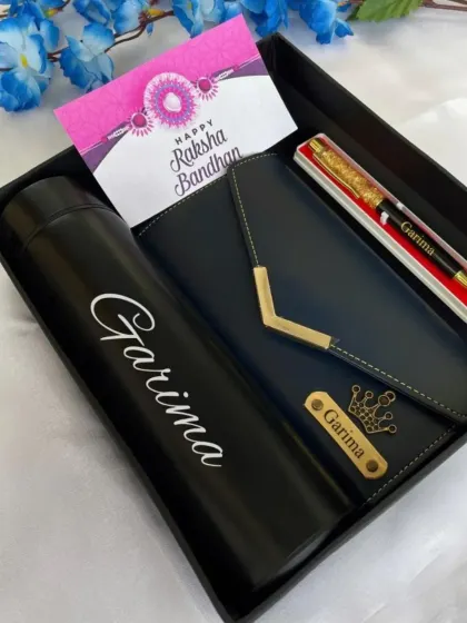 A special Rakhi hamper designed for a sister. It includes a personalized temperature bottle, a custom 3-fold clutch with her name and a crown charm, and a name-engraved pen.