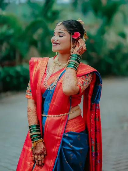 A joyful candid of the bride, with a flower in her hair and a beautiful smile. This photo perfectly captures her happiness and radiance.