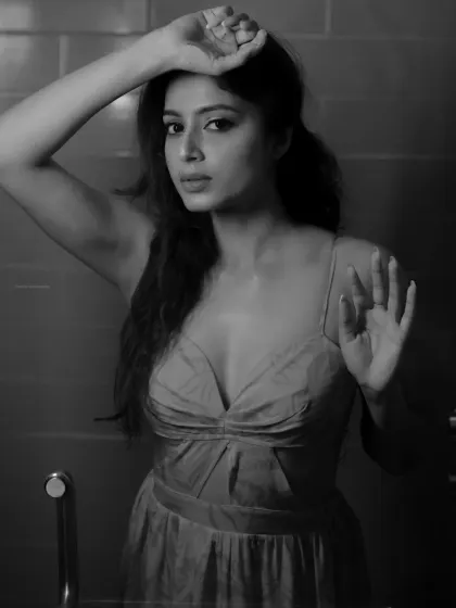 A different take on the black and white portrait, with the model interacting with the glass. This adds a layer of narrative and mystery.