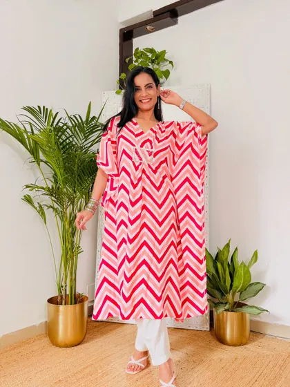 This pink chevron print kaftan is a fun and playful option. The colors are bright and happy, perfect for summer.