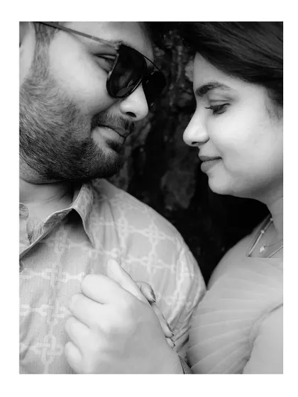 A tender black and white close-up of a couple, focusing on their gentle expressions and connection.