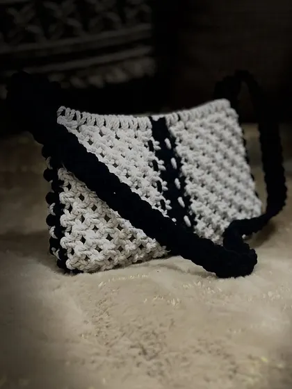 Another artistic shot of the baguette bag, highlighting its clean lines and handmade quality.