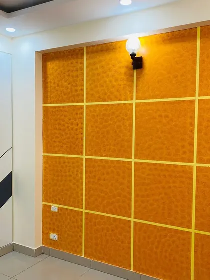 A bedroom with a bold yellow textured feature wall and a dual-tone wardrobe. This is a great way to add personality to a room.