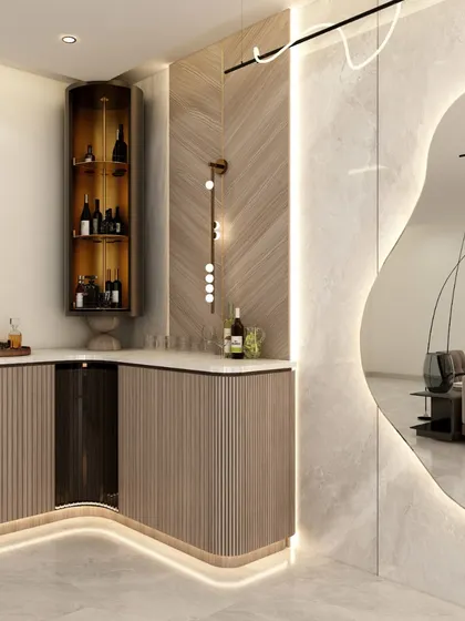 A closer look at the custom bar unit, with its curved form, under-counter lighting, and a mix of open and closed storage for a functional yet stylish setup.
