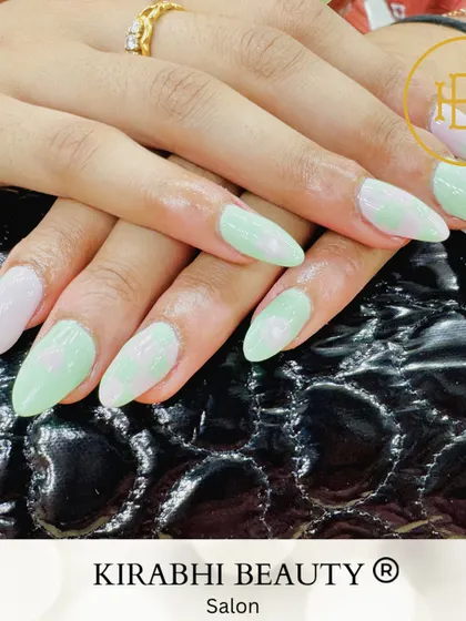 Soft and sweet pastel nail art. This look combines a mint green base with a subtle pink heart design for a cute and understated manicure.