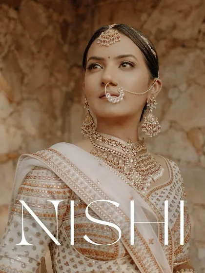A stunning bridal portrait captured during the golden hour. The warm light illuminates her face and intricate jewelry.