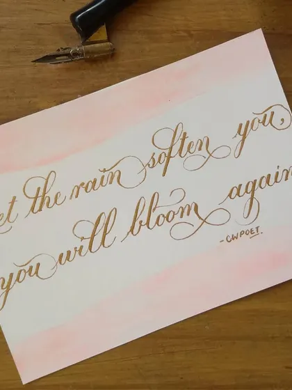 "Let the rain soften you, you will bloom again." A beautiful quote paired with a soft pink watercolor wash and shimmering gold calligraphy. It’s a message of hope and resilience.