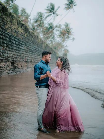A sweet and intimate moment captured on a cloudy day at the beach.