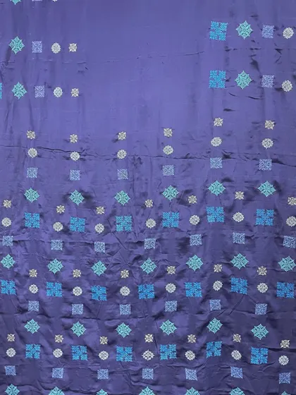 A contemporary take on Kasuti, with geometric motifs arranged in a modern, cascading pattern on a navy blue crepe silk. This shows how a traditional craft can be adapted for today's aesthetic.