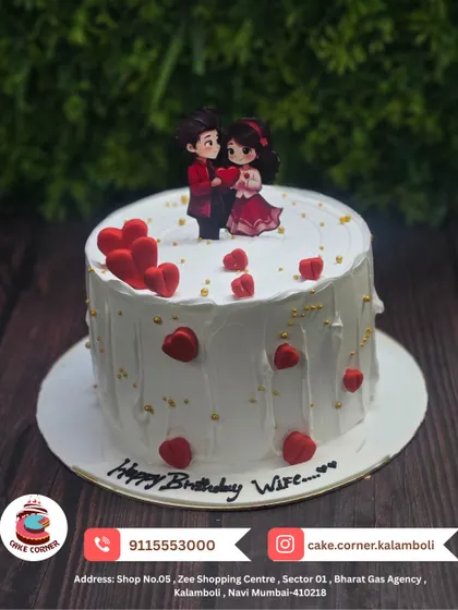 A sweet cake for a wife's birthday, decorated with red hearts and a cute couple topper. A lovely way to show your love and appreciation.