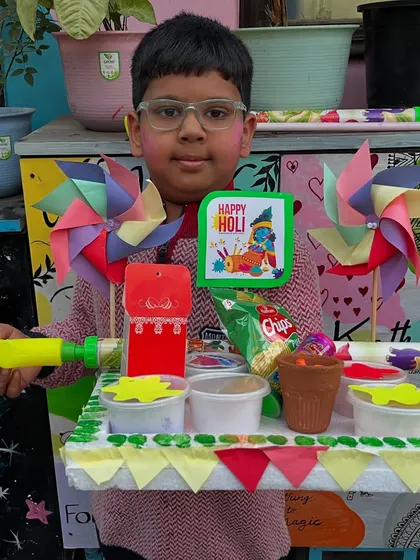 A student with his impressive Holi platter, which includes snacks and handmade decorations.