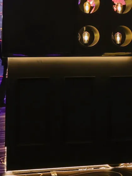 A detail of the sleek, modern bar design, showing the clean lines and integrated lighting that define its sophisticated look.