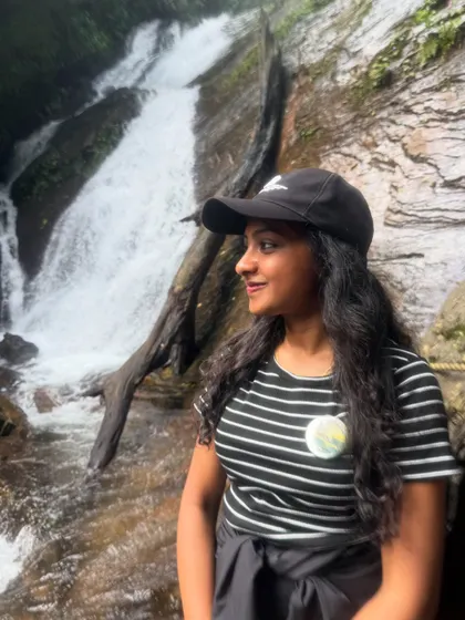 A trekker enjoying a quiet moment by a smaller cascade on the way to the main Hidlumane Falls.