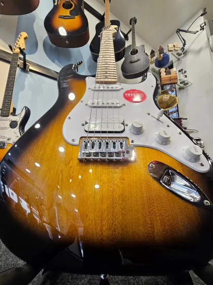 The iconic Fender FSR Stratocaster HSS in a timeless 2-Tone Sunburst finish. This close-up shows the beautiful wood grain and classic design that has defined generations of music. It represents the perfect blend of vintage feel and modern versatility we stock.
