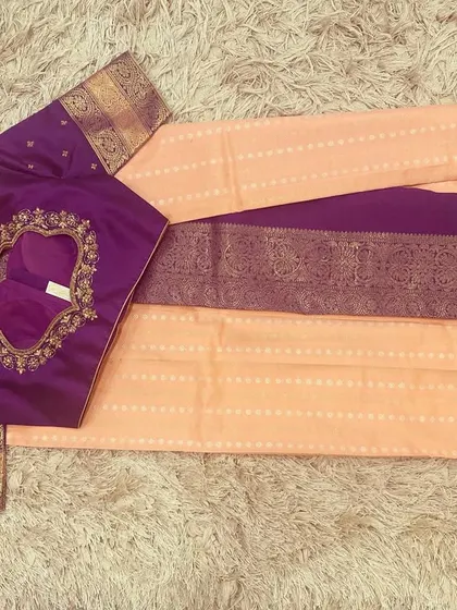 The back of the violet blouse, showing the intricate embroidery around the neckline.