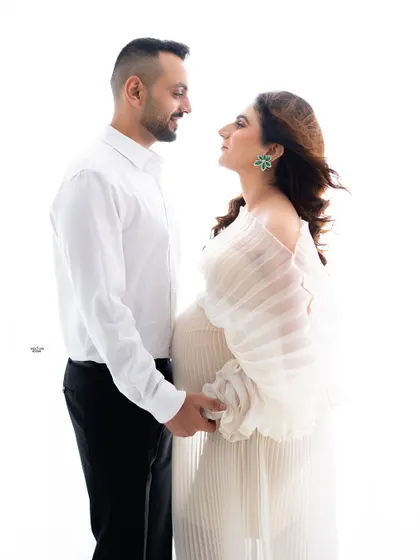 A classic pose, holding hands and looking at each other. You can feel the deep connection and love between them.
