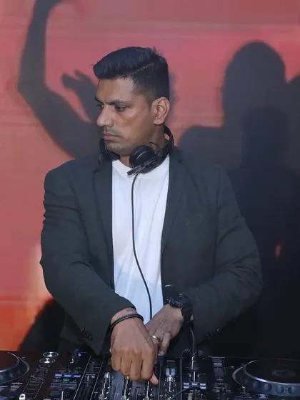 Another angle from the Diwali event, showing my concentration while mixing against a backdrop of visual projections.