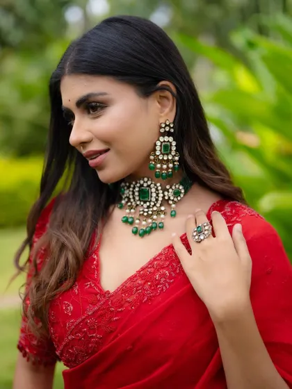 A close-up profile shot. This angle highlights the intricate design of the earrings and necklace, as well as the bride's elegant features.