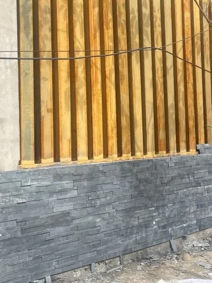 A close-up of the material palette in progress at the Good Shepherd Cathedral site. Here, we are combining natural stone cladding with vertical wooden elements to create a textured, modern facade.