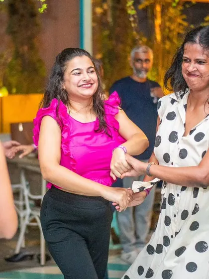Two friends dancing together and having a great time.
