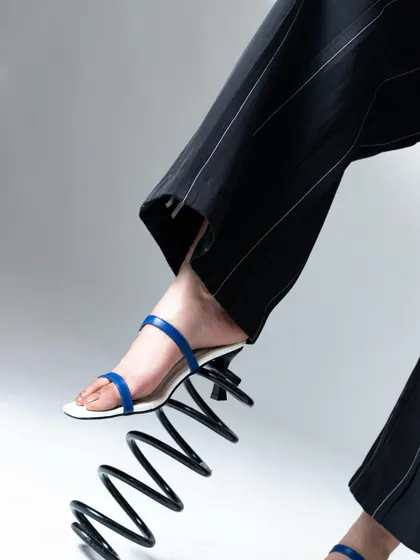 Getting creative with props. This giant spring added a playful and unexpected element to the footwear shoot.