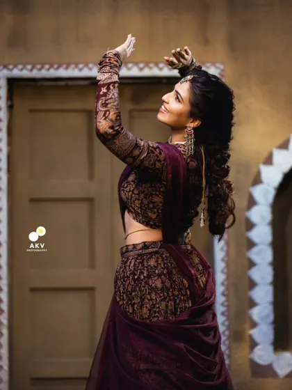 A graceful, dynamic pose from the Deepawali shoot. The intricate hairstyle and detailed outfit are beautifully captured in this shot.