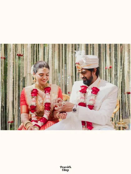 The couple exchanges rings during their South Indian wedding, a simple, beautiful frame capturing this symbolic ritual.