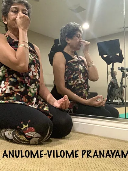 Practicing Anulome-Vilome Pranayam, or alternate nostril breathing. You can see my reflection, a reminder that this practice is about looking inward and finding balance.