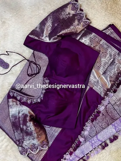 Another angle of the purple blouse and saree set, showcasing the beautiful drape and the coordinated design.