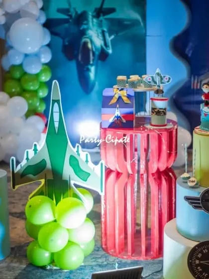 The dessert table for the fighter jet party, featuring a themed cake, jet cutouts, and balloon clouds. Every detail was designed to fit the high-energy theme.