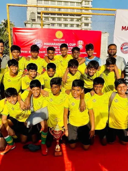 The victorious football team celebrating their win at the FC Bayern Munich Maharashtra Cup.