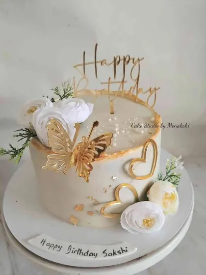 This white and gold design is one of my most requested, and it's easy to see why. Adorned with a golden butterfly, hearts, and white flowers, this no-fondant cake is simply beautiful.