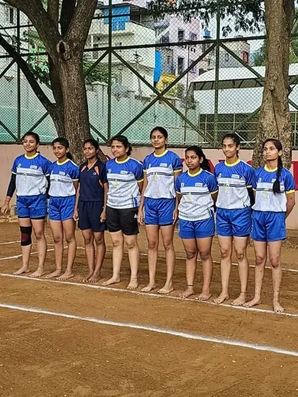 Our girls' Kabaddi team lined up and ready for action on the dirt court.