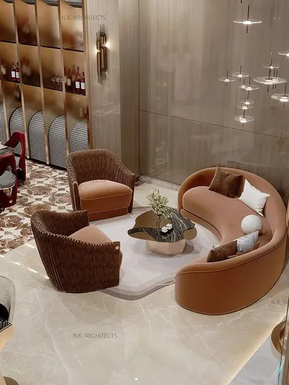 An overhead view of a double-height living and dining area. The layout is designed to host both formal dinners and cozy family gatherings, with a curved sofa defining the lounge space next to the grand staircase.