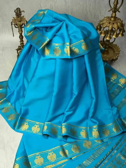 A sky-blue pure silk saree with a traditional gold border featuring elephant motifs. This saree is light, elegant, and perfect for ceremonies and cultural events.
