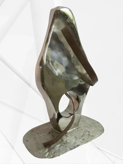 "The Lady," a throwback to an earlier work. This piece explores a feminine form using polished steel and contrasting bronze-toned bands.