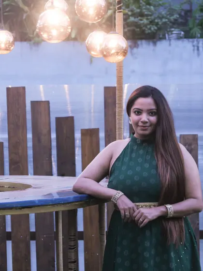 Posing at an evening social event. The soft lighting and rustic decor complemented my fusion wear, showcasing its versatility for both daytime and evening functions.