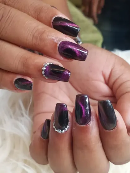Another view of the captivating purple cat-eye manicure, showing the light-shifting properties of the polish.