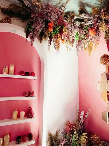 The registration area for the "Fireworks" event was designed to be an experience in itself, with floral clouds hanging from the ceiling and artfully arranged niches.