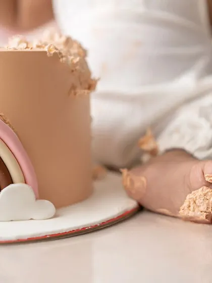A close-up of the messy fun! Those little feet covered in cake are just the cutest detail from a first birthday celebration.