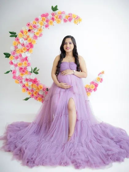 A dreamy portrait on a floral moon. This creative prop adds a touch of magic to the photo, with the mom-to-be looking serene in a lavender gown.