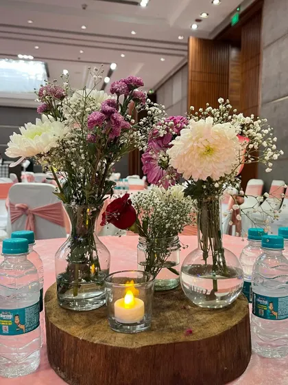 Another view of the lovely rustic wood slice centerpiece. The mix of chrysanthemums, carnations, and baby's breath creates a soft and natural look.