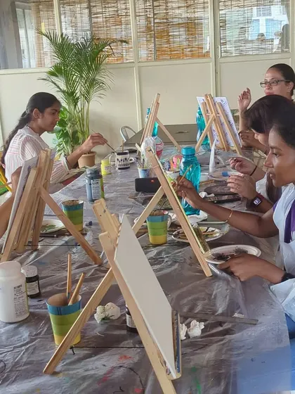 A long shot of our canvas painting workshop, with participants at their easels, focused on their masterpieces.