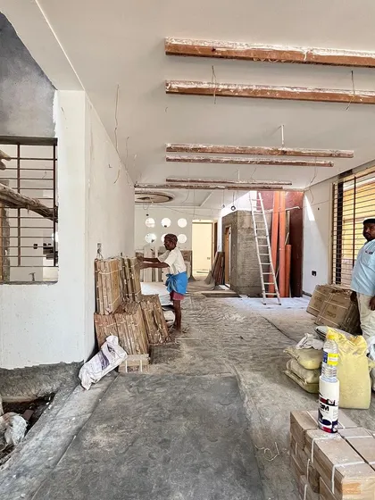 A wide shot of a project site during the construction phase, showing the raw structure and the beginning of the transformation.